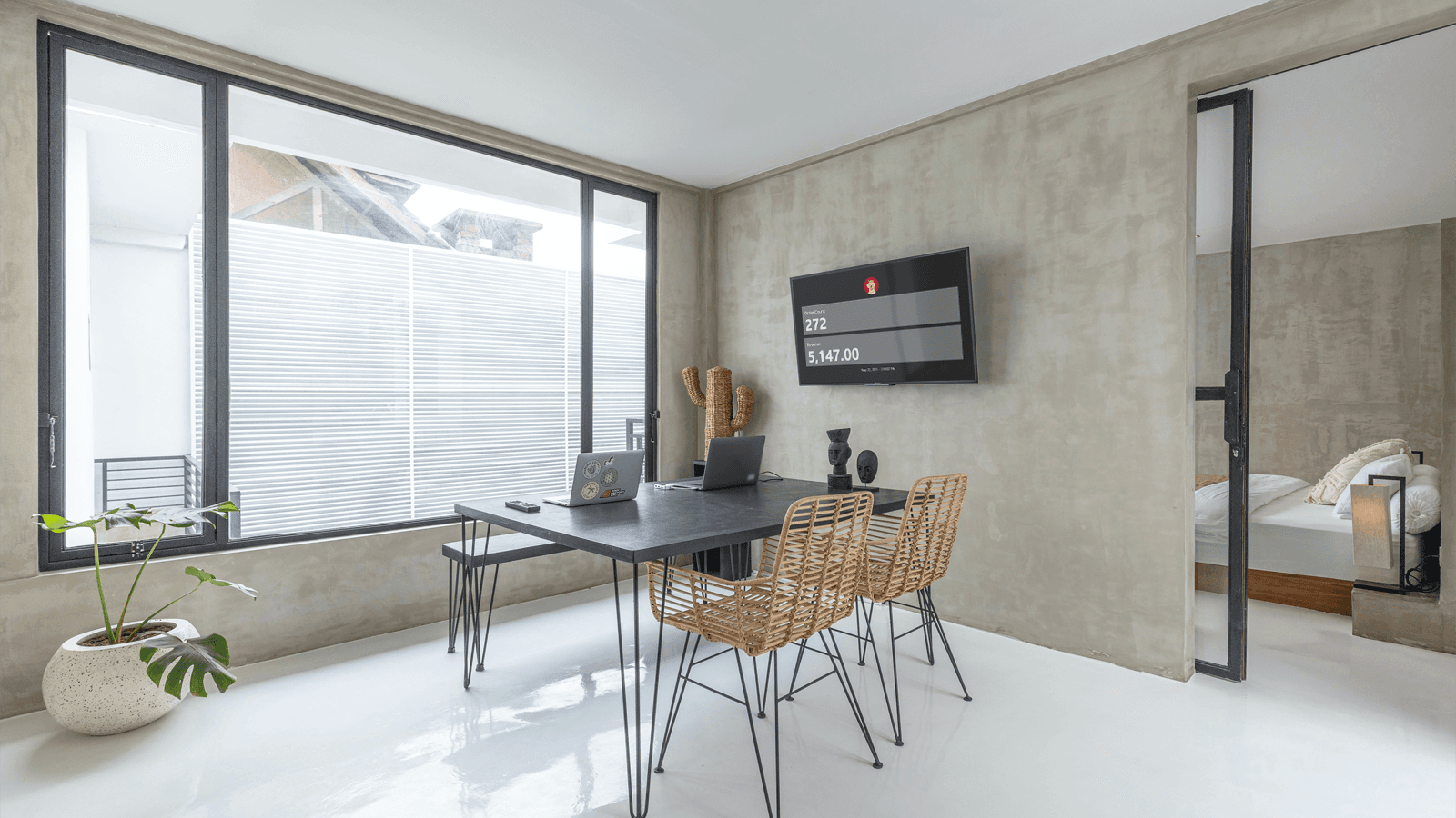 Home office with sales dashboard on TV